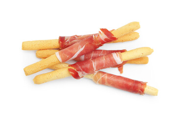 Delicious grissini sticks with prosciutto isolated on white, top view