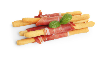 Delicious grissini sticks with prosciutto and basil isolated on white, above view