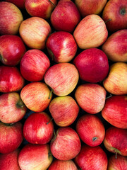 A top view photo of ripe apples neatly arranged and filling the entire frame. The apples create a colorful food background, perfect for themes of health, nutrition, farming, and seasonal harvest.