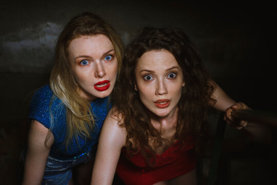Frightened women in basement during Halloween horror thriller scene