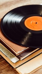 Vinyl record on top of a stack of books creating a vintage aesthetic scene look
