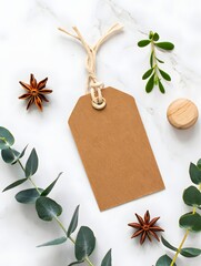 Blank tag with eucalyptus and star anise on white marble background surface is nice