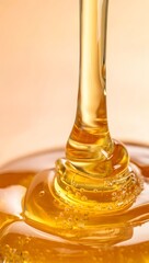 Golden honey pouring with a smooth and viscous texture on a soft background color