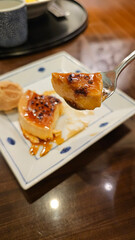 Eating Handmade Caramel Baked Pudding Crème Caramel with Spoon in a Retro Showa-Era Café, Traditional Dessert and Afternoon Tea Experience in Japan