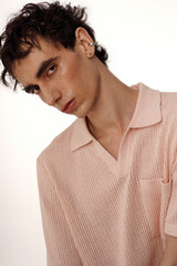 Stylish man showcasing elegance with unique fashion sense in a minimalist setting