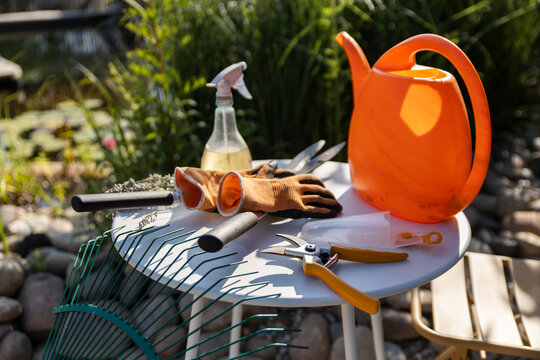Gardening tools and eco-friendly equipment on outdoor table in sunshine