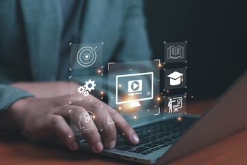 Businessman using laptop with futuristic icons of online education, e-learning, digital training, and knowledge sharing, symbolizing modern technology, virtual learning, and professional growth.