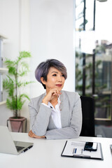 Obraz premium Happy dreamy mature senior business woman looking away at copy space and dreaming, planning. Smiling smart older 50s lady thinking of new opportunities vision .