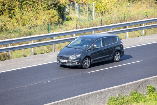 Ford s-max minivan driving on highway road