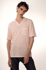 Fototapeta premium Elegant modern man exudes charm and style in light attire during a fashion showcase