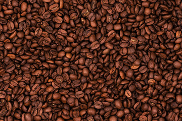 Freshly roasted coffee beans background texture. Close-up, top view.