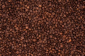 Freshly roasted coffee beans background texture. Close-up, top view.