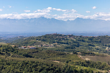 Naklejka premium View of the Langhe-Roero hills and vineyards in Piedmont with the Alps in the background. Italy
