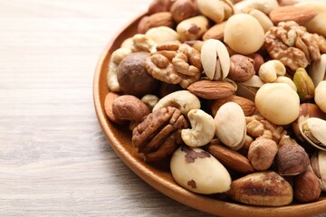 Mix of different nuts on wooden table, closeup. Space for text