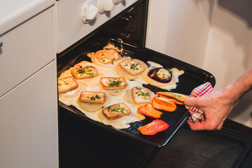 Putting food into the kitchen oven
