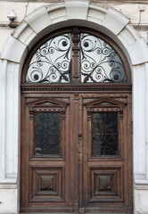 Vintage wooden brown door close-up with insertions and patterns on glass