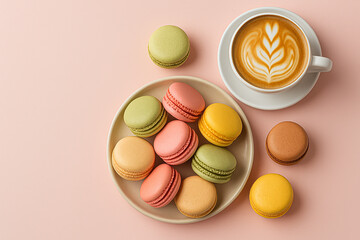 Multicolored French macarons on a plate, next to a cup of cappuccino with a pattern on a light pink background. Top view.