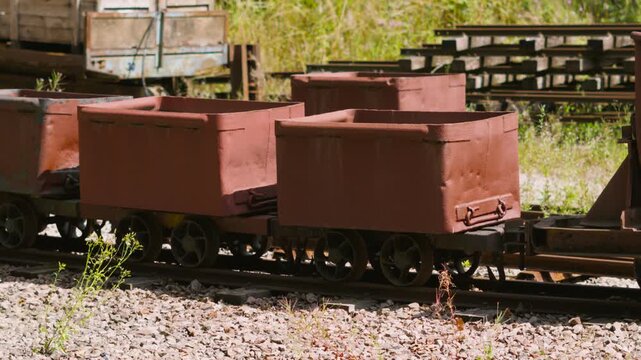 Old Rusting Coal Carts on Narrow Gauge Rail for Carrying Fuel to Power Steam Trains.