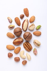 Obraz premium Mix of different nuts on white background, flat lay