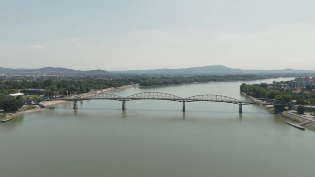 A scenic aerial view showcasing the M&aacute;ria Val&eacute;ria Bridge over the Danube River in Esztergom