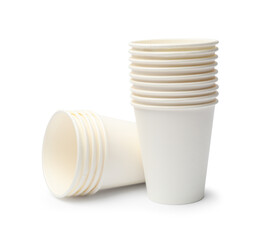 Obraz premium Disposable tableware. Stacks of paper cups isolated on white