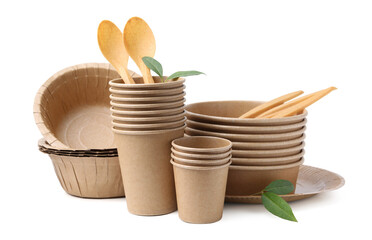 Set of disposable tableware and leaves isolated on white