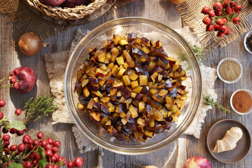 Diced fresh plums, apples, ginger, onion and spices - preparation of chutney - homemade relish