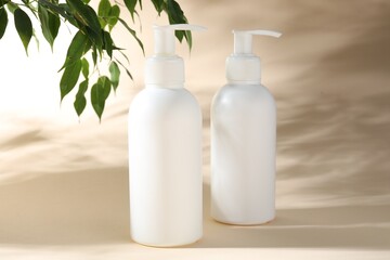 Promotion. Cosmetic products and green leaves on beige background
