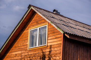 The house is made of wood with a slate roof.