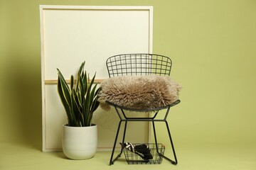 Stylish chair and other used stuff on olive background