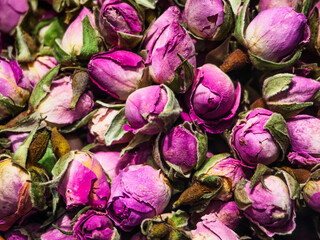 Dried pink rose buds arranged in a colorful display showcasing their natural beauty and texture