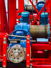 Machinery in operation at an industrial site showcasing motors and cables in vibrant colors