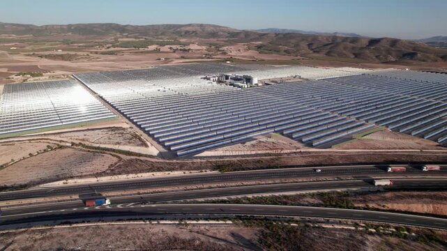 Solar thermal power plant with parabolic mirrors in a dry landscape. Renewable energy technology for clean electricity production and environmental sustainability.