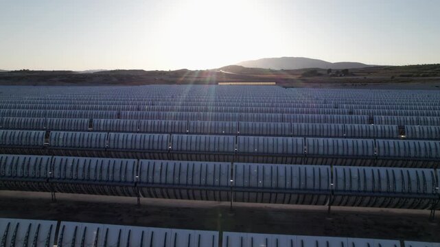 Solar thermal power plant with parabolic mirrors in a dry landscape. Renewable energy technology for clean electricity production and environmental sustainability.
