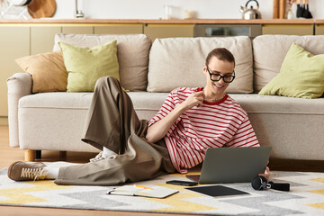 Young handsome man enjoys time at home while using laptop, surrounded by cozy decor