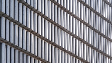 Modern building facade with alternating concrete and metal panels