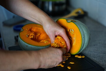 Removing pumpkin seeds with hands