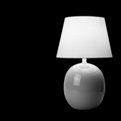 A light blue ceramic table lamp with a white lampshade isolated on transparent background