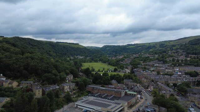 aerial view of the town of Todmorden in West Yorkshire showing the streets public park and surrounding hills