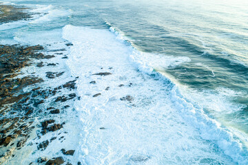 An aerial view of a wild rocky coast with powerful ocean waves, Dramatic Seascape