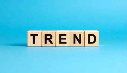 流行を表す英語のフレーズTRENDの文字が書かれたキューブブロック。青い背景。 aiで生成	