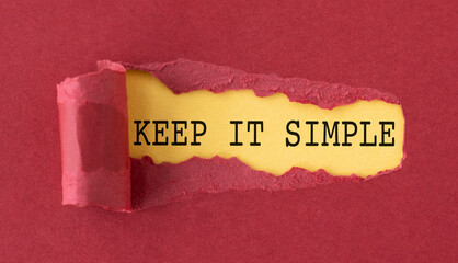 A torn piece of paper with the words Keep it Simple written on it