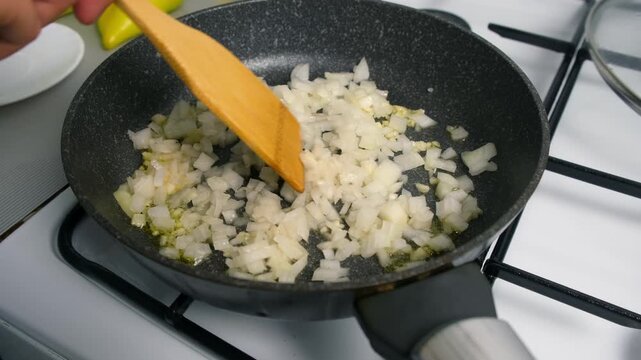 Chef woman cooking stirring chopped onions and garlic in frying pan on kitchen. Culinary techniques, homemade preparing healthy meal, cook food dish, cuisine, seasoning for meal good taste.