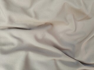 Fototapeta premium Brown silk satin texture background, Beautiful wavy soft folds on the surface of the fabric
