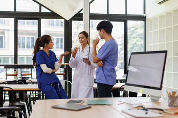 Pharmaceutical sales representative talking with doctors in medical building, presenting new medication on tablet. Hospital director, manager in modern clinic with doctor and nurse.
