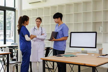 Pharmaceutical sales representative talking with doctors in medical building, presenting new medication on tablet. Hospital director, manager in modern clinic with doctor and nurse.
