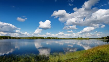Fototapeta premium a tranquil blue sky with gentle cumulus clouds and a serene lake in the foreground atmospheric landscape