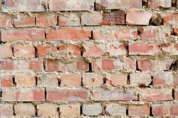 Weathered brick wall close-up background.