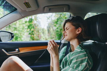 woman resting inside car interior, eyes closed, relaxed expression, peaceful moment, comfortable seat, soft light, calm mood, serene journey vibe, quiet atmosphere
