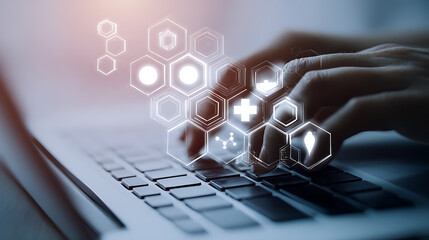 Hands typing on a laptop keyboard with digital hexagonal patterns and glowing symbols floating above, representing technology and data interaction.